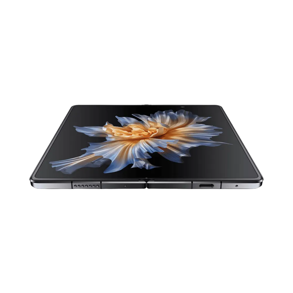Honor Magic Vs noir affiché en position ouverte et posé à plat, grand écran pliable lumineux avec motif fleur dorée, parfait pour représenter réparations écran pliable et composants internes chez iTelier Lyon.