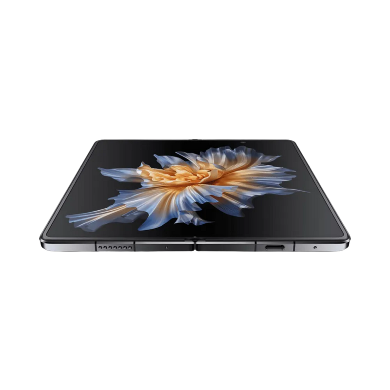 Honor Magic Vs noir affiché en position ouverte et posé à plat, grand écran pliable lumineux avec motif fleur dorée, parfait pour représenter réparations écran pliable et composants internes chez iTelier Lyon.